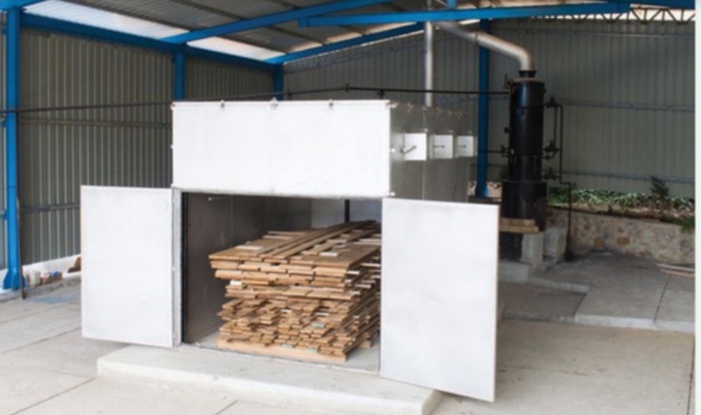 The timber seasoning chamber at Wada, loaded with stacked sawn timber.